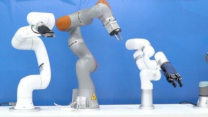 Different collaborative robot arms with grippers showcased side by side. Robot arm demonstrates...