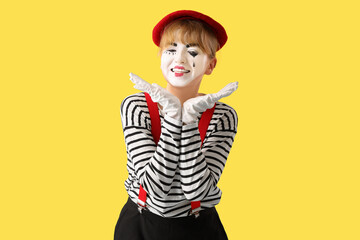 Female pantomimist on yellow background