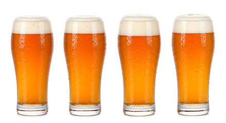 Four Refreshing Glasses of Golden Juice with Frothy White Heads and Condensation Droplets, Perfect for a Summer Celebration or a Relaxing Evening
