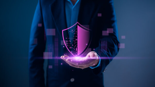 Person holding glowing purple shield with circuit patterns, symbolizing cybersecurity, data protection, privacy, and secure digital technology solutions.