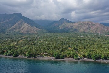 Dramatic Coastal Landscape of North Bali with Jungle Shoreline and Mountain Range