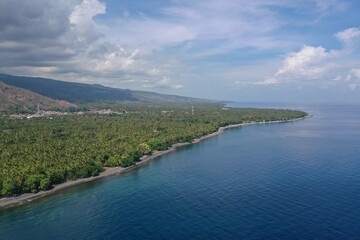 Dramatic Coastal Landscape of North Bali with Jungle Shoreline and Mountain Range