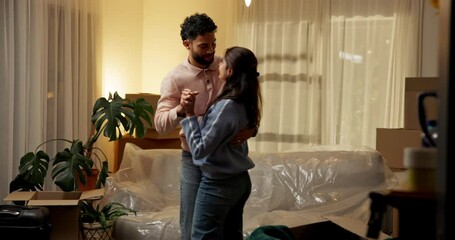 Moving in, night and couple with dancing in new house for property investment, relocation or goals. Evening, people and celebration in first home for mortgage security, freedom or real estate success