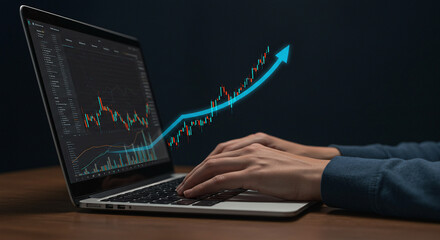 Hand on laptop keyboard with business graph on screenHand on laptop keyboard with business graph on screen
