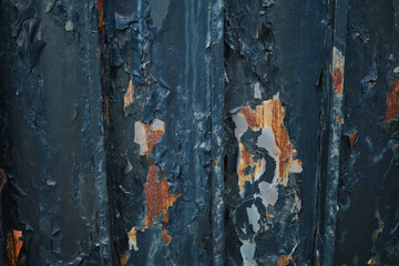 Rusty iron walls with paint beginning to peel. Brown rust. Deterioration over time. Wall.