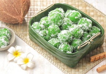 Klepon, also known as onde-onde, is a type of cake or steamed snack made from rounded sticky rice flour, filled with brown sugar and spread over grated coconut until it sticks.