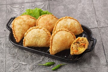 Pastel Goreng in Indonesia, pastel refers to a type of kue filled with meat, vegetables, and rice vermicelli deep fried in vegetable oil. It is consumed as a snack and commonly sold in Indonesian trad