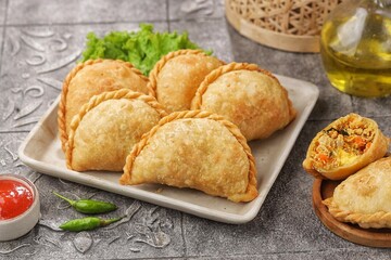 Pastel Goreng in Indonesia, pastel refers to a type of kue filled with meat, vegetables, and rice vermicelli deep fried in vegetable oil. It is consumed as a snack and commonly sold in Indonesian trad