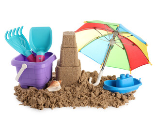 Castle made of sand, beach toys and small umbrella on white background