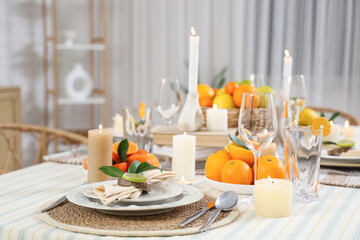 Dining table decorated with citrus fruits in room. Closeup
