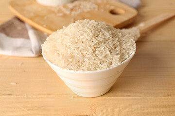 Bowl of raw rice on table. Closeup