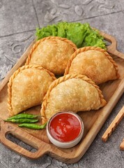 Pastel Goreng in Indonesia, pastel refers to a type of kue filled with meat, vegetables, and rice vermicelli deep fried in vegetable oil. It is consumed as a snack and commonly sold in Indonesian trad