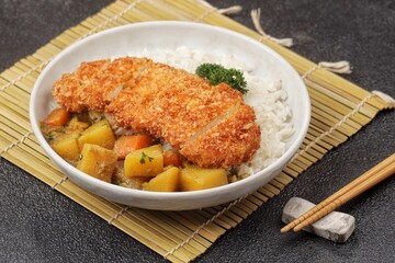 Chicken Katsu Curry is a Japanese curry dish with chicken katsu, sliced ​​chicken meat coated in crispy flour.