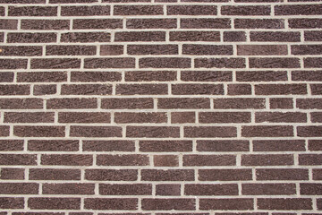 Background of an old European wall made of red-brown bricks with white mortar joints. Rustic...