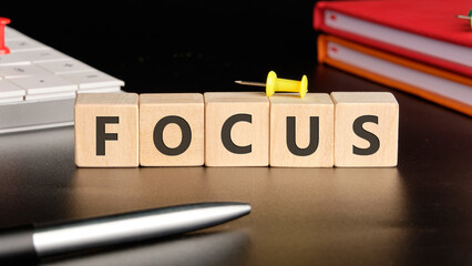The concept word FOCUS is assembled from cubes. Search for words and information concept