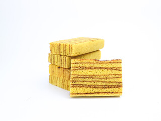 Indonesian layered cake slices (kue lapis legit) stacked on white background. Traditional sweet...