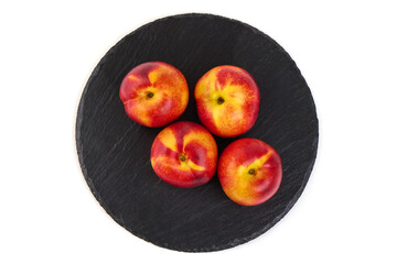 Nectarines on Slate Plate, isolated on white background