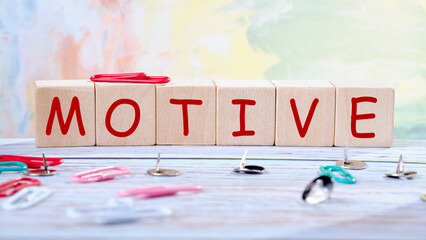 The concept word MOTIVE is assembled from wooden cubes. business motivational concept
