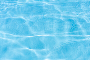 Blue water with ripples on the surface. Defocus blurred transparent blue colored clear calm water...