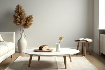 Serene minimalist living room interior design featuring a round coffee table with a slice of bread and a glass of milk, accompanied by dried flowers in a vase and a neutral-toned sofa