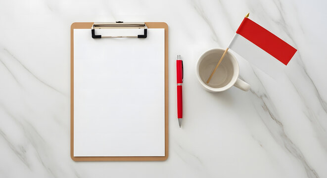 Red and white Indonesian flag decorates a clipboard with a pen on a marble surface for Independence Day concept