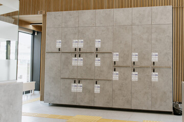 Modern secure storage lockers with digital code locks and user instructions, located in a...