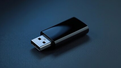 A sleek, black USB flash drive on a dark surface, showcasing its modern design and utility.