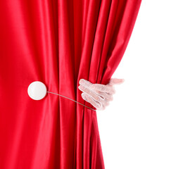 Female hand opening red velvet curtain isolated on white background