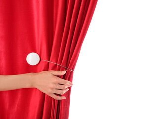 Female hand opening red velvet curtain on white background