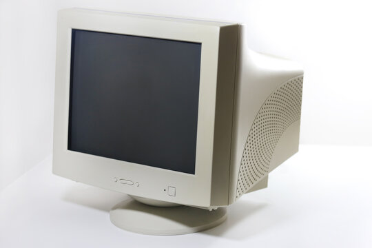 A side view of an old-fashioned beige CRT monitor, a symbol of past computing eras.