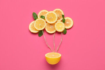 Composition with fresh sliced lemons and mint on pink background
