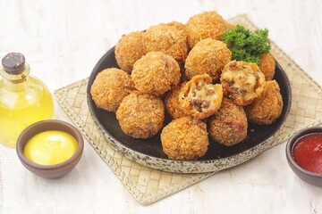 Bitterballen is the name of a type of food in the Netherlands. Bitterballen taste similar to croquettes, but are small round shapes about 3 to 4 cm