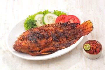 Ikan Bakar. Grilled fish is a fish dish that is grilled or roasted over a fire or embers.