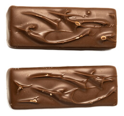 Broken chocolate bars with caramel and nougat filling, closeup of crispy snack candies with rich...