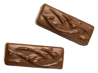 Broken chocolate bars with caramel, nougat, and peanuts on a black background, closeup of sweet snack with glossy texture and creamy filling