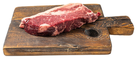 Juicy, marbled raw ribeye steak on rustic wooden cutting board isolated on transparent background