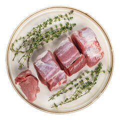 Fresh raw pork tenderloin medallions with herbs on a rustic ceramic plate, isolated transparent...