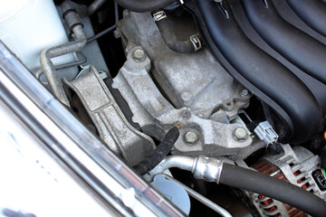 Obraz premium Upper engine mount close up. Gasoline engine parts. Engine mount in the upper part of car. Engine parts under the hood of the car.