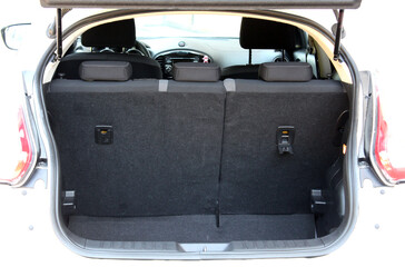 Open back door white modern SUV. Modern SUV trunk. Close up car trunk. Modern vehicle have an open...