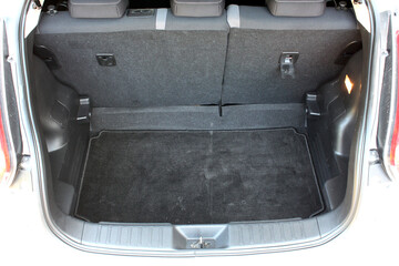Open back door white modern SUV. Modern SUV trunk. Close up car trunk. Modern vehicle have an open...
