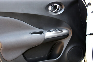 Modern SUV door trims. Modern car interior. Front door panel. Inside car door. Interior handle in car interior.