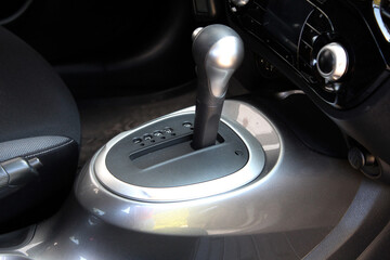 Automatic transmission gearshift stick. New car interior. Сar center console with cup holders....