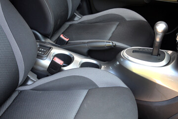 Grey fabric Driver and passenger seat of new car. Textile Interior of modern car. The gear shift lever of an automatic transmission on the center console of a car.