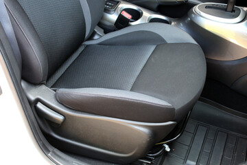 Fototapeta premium Gray textile drivers seat in a luxury SUV. Fabric car interior. Gray drivers seat in the car. Front seats of a modern passenger car.
