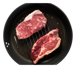 Fresh marbled ribeye steak cuts on grill pan highlighting raw red meat, flavorful texture, and appetizing appearance