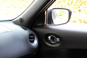 Car air conditioner ventilation grille. Automotive climate control. Airflow inside the car. Interior element of a modern car. Chrome interior car door handle. Inner chrome door handle close up.