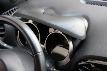 Car dashboard visor. Car dashboard. New modern car interior. Upper part of leather car steering...