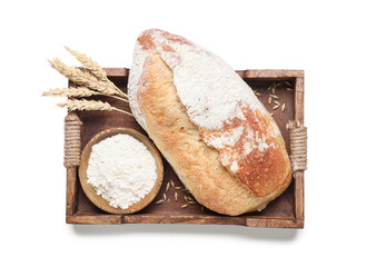 Wooden tray loaf of fresh bread, flour and wheat ears isolated on white background