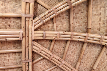 A close-up view of a meticulously crafted bamboo and woven mat ceiling, showcasing traditional Indonesian architectural details.