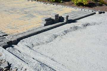 Laying paving slabs in the garden in front of the house